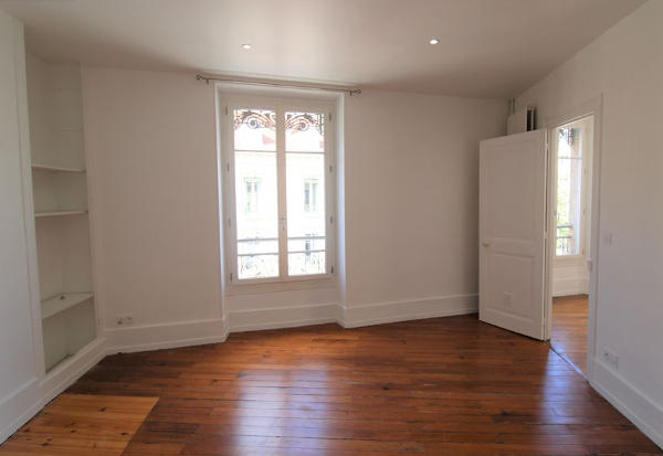 white room with wooden floors in an empty for rent apartment
